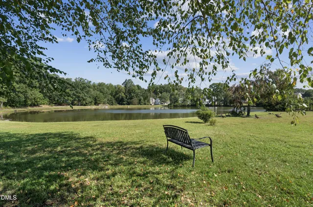 a swimming pool with outdoor seating and garden