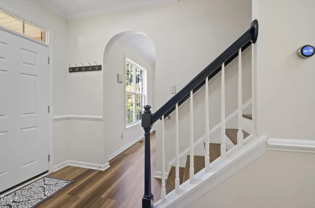a view of entryway with wooden floor and stairs