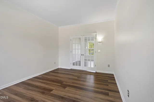 a view of wooden floor and windows in a room