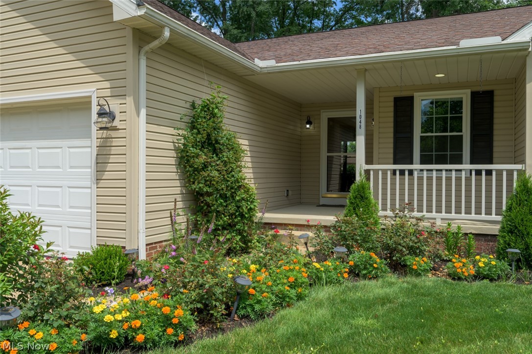 1048 Susan Road Ravenna, OH 44266 - Photo 15 of 35 Front exterior featuring light-colored siding and a brown shingle roof