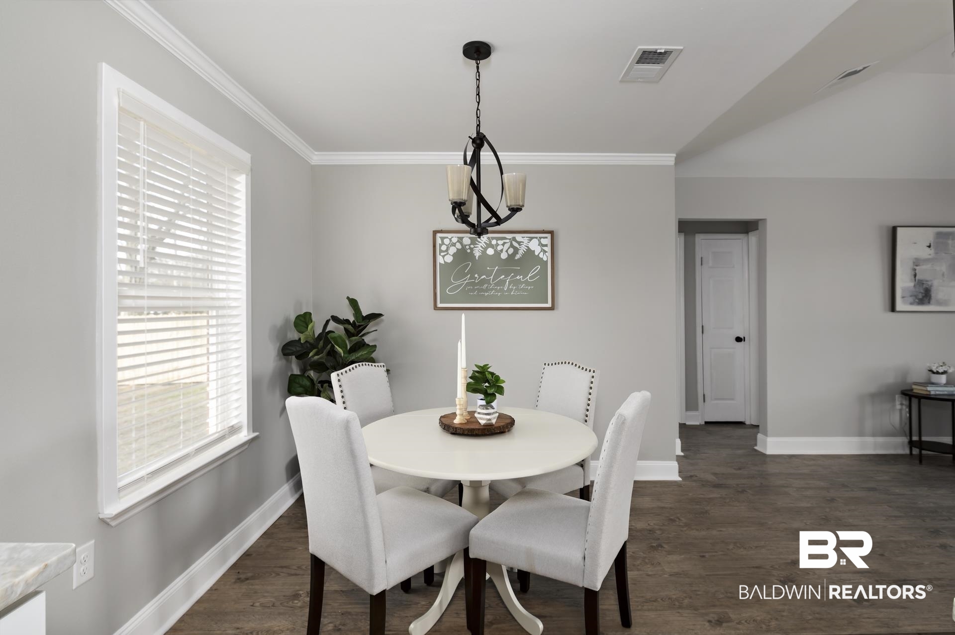 21717 Shadowbrook Street Robertsdale, AL 36567 - Photo 18 of 32 Dining room featuring dark wood-style floors, baseboards, visible vents, and crown molding
