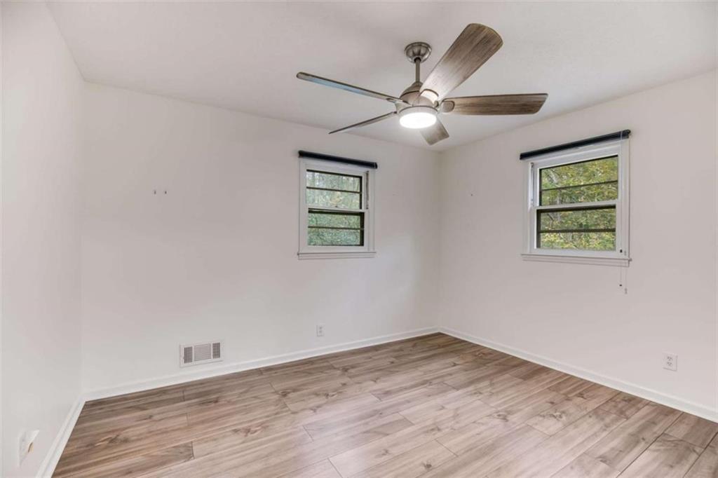 104 Eaves Road Bremen, GA 30110 - Photo 16 of 29 an empty room with wooden floor ceiling fan and window