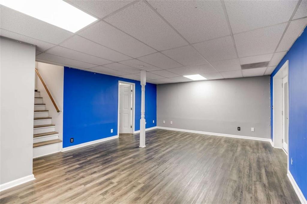 104 Eaves Road Bremen, GA 30110 - Photo 18 of 29 a view of an empty room with wooden floor and stairs