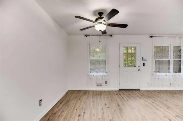wooden floor in an empty room with a window