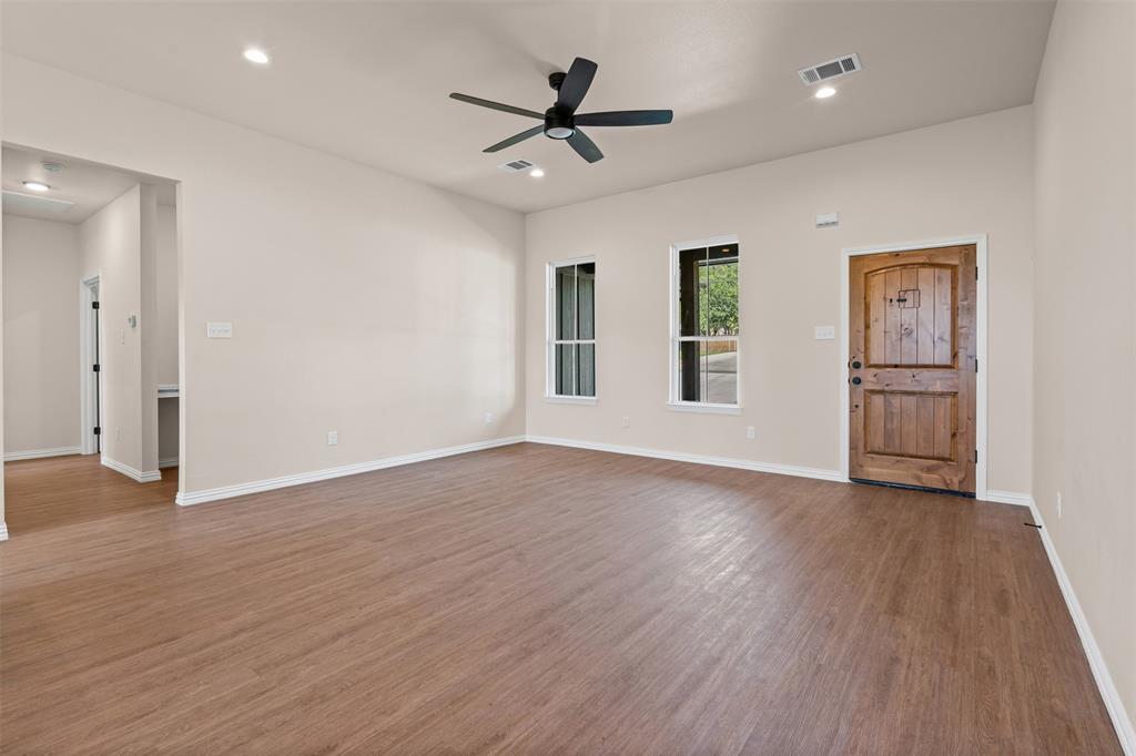 a view of a livingroom with a hardwood floor and a ceiling fan