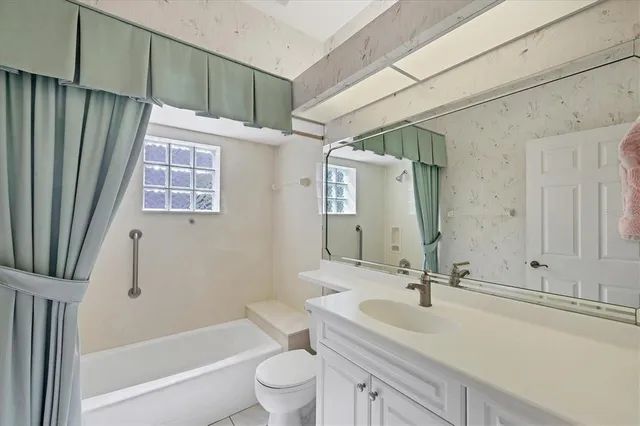a bathroom with a sink toilet double vanity tub and shower