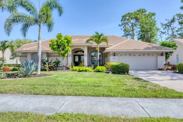 a front view of a house with a garden