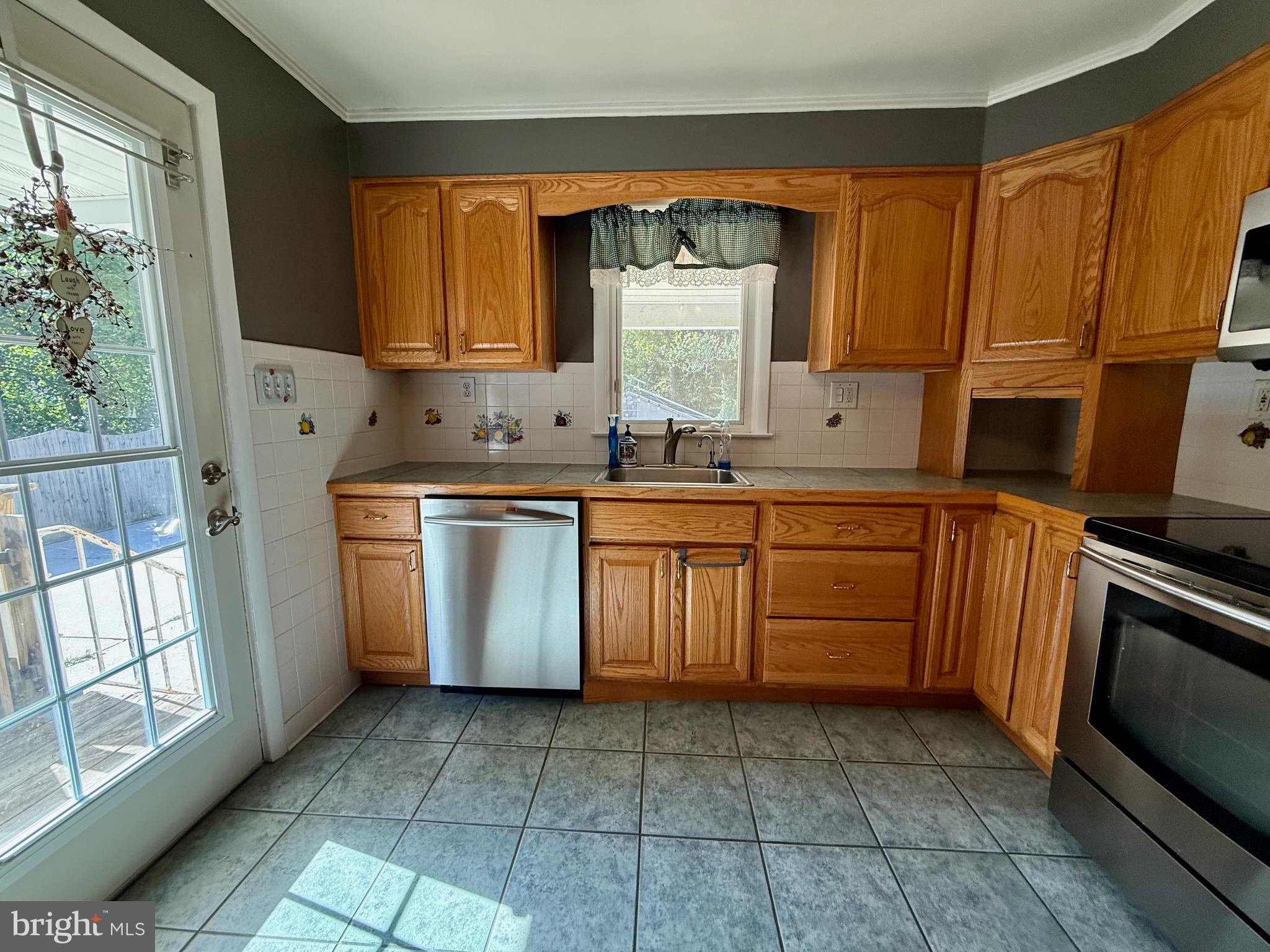3817 Schroeder Avenue Perry Hall, MD 21128 - Photo 14 of 48 a kitchen with a sink stove top oven and cabinets