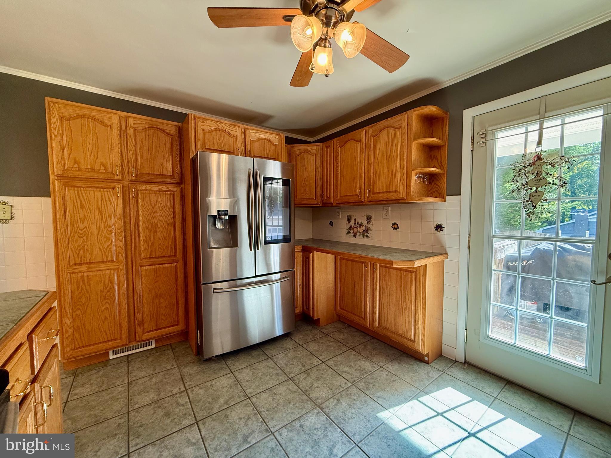 3817 Schroeder Avenue Perry Hall, MD 21128 - Photo 15 of 48 a kitchen with stainless steel appliances granite countertop a refrigerator a sink and dishwasher with a large window