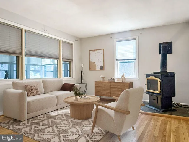 a living room with furniture a rug and a window