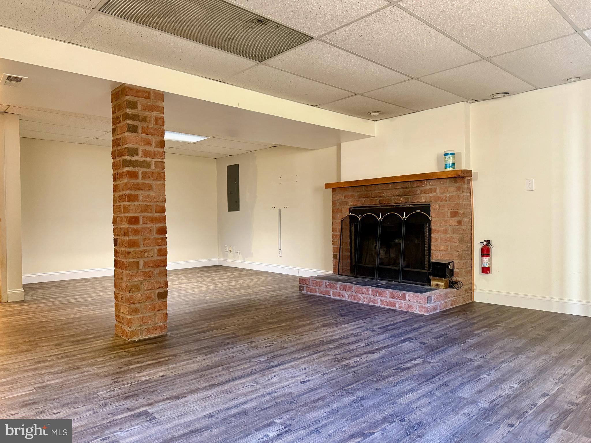 3817 Schroeder Avenue Perry Hall, MD 21128 - Photo 30 of 48 a view of empty room with wooden floor and fireplace