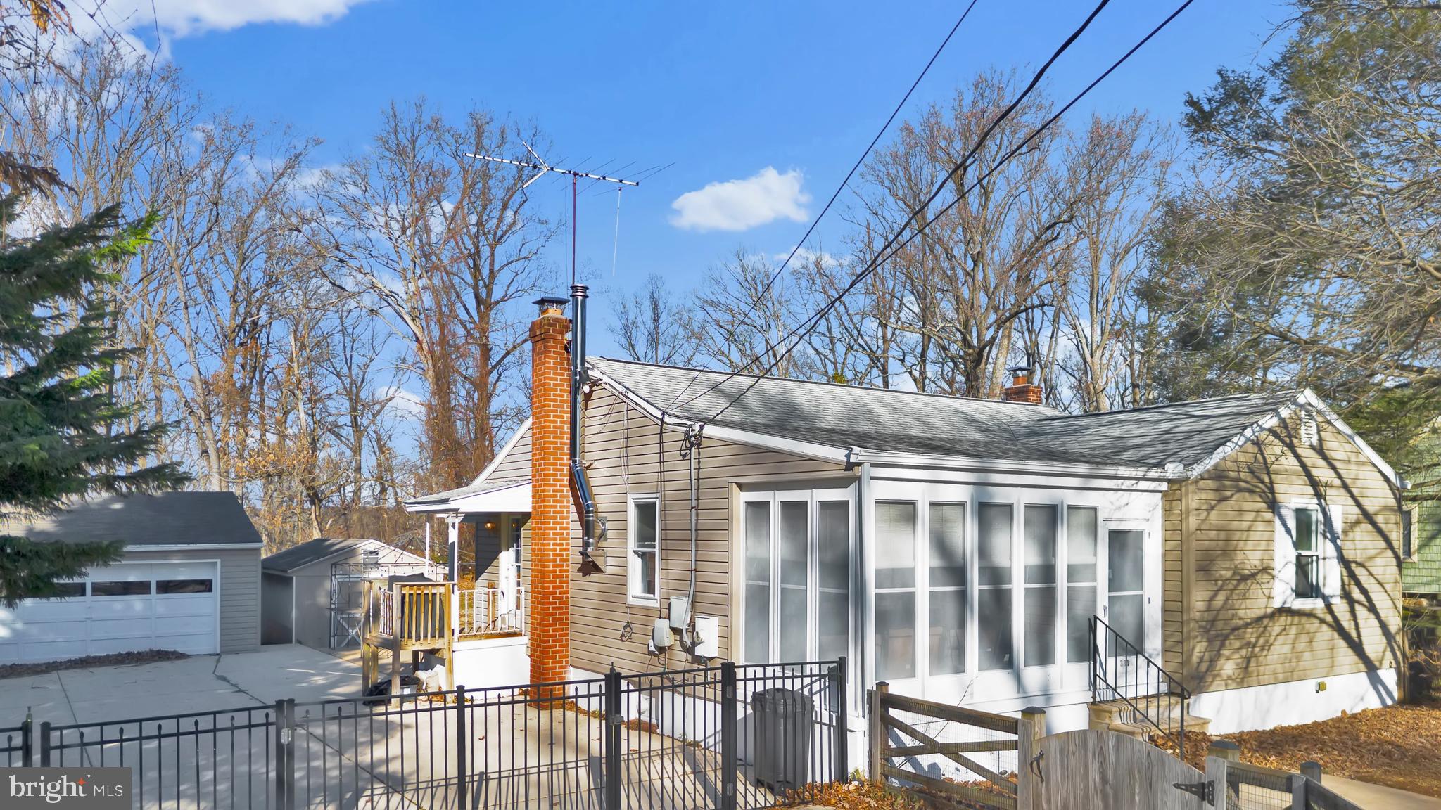 3817 Schroeder Avenue Perry Hall, MD 21128 - Photo 3 of 48 a view of a house with large windows and a table and chairs