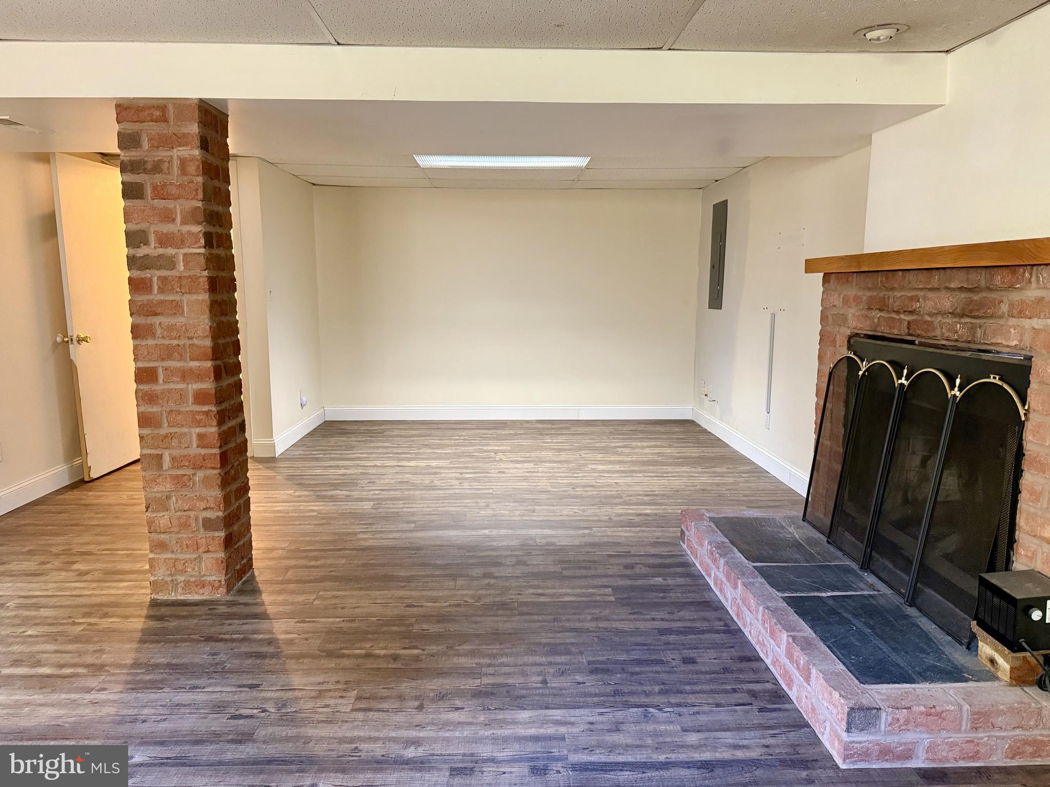 3817 Schroeder Avenue Perry Hall, MD 21128 - Photo 31 of 48 a view of a living room with wooden floor and a fireplace