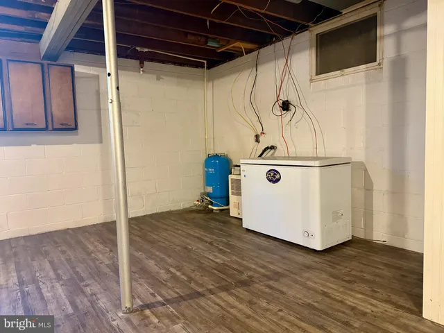 a utility room with wooden floor and white doors