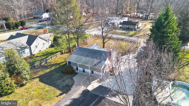 a view of a patio with table and chairs with wooden fence and plants