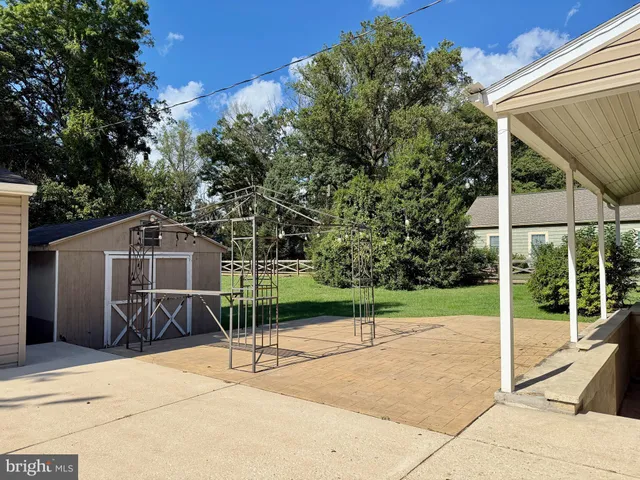 a view of a house with a backyard and a patio