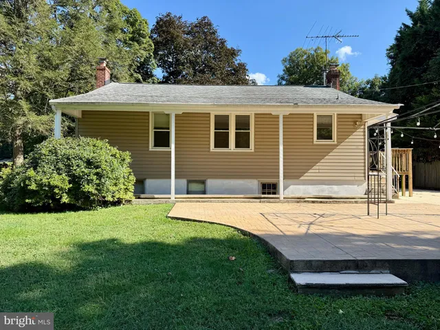 a view of a house with a yard and sitting area