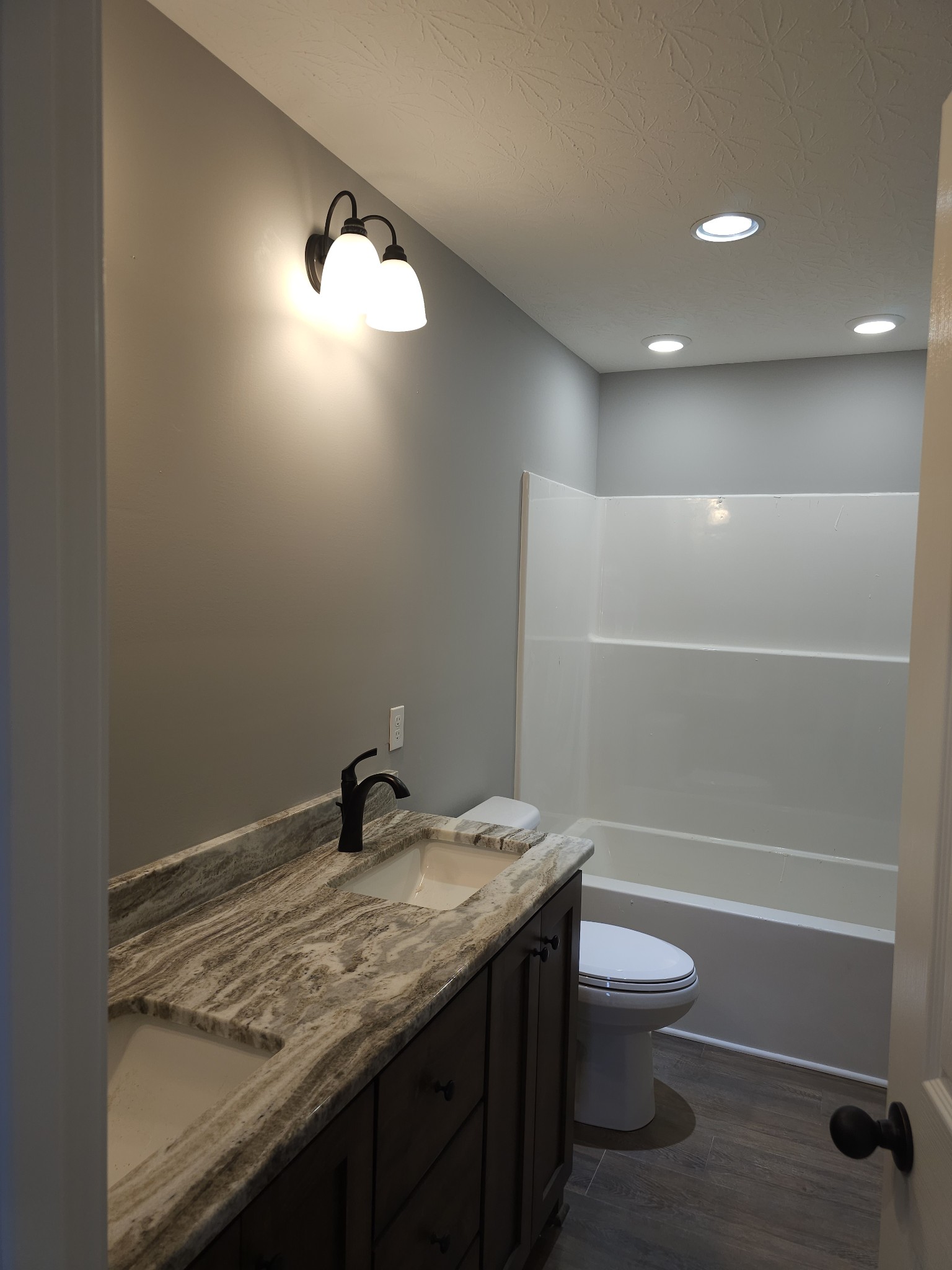 5209 Galen Road Lafayette, TN 37083 - Photo 14 of 24 a bathroom with a granite countertop sink a toilet and shower