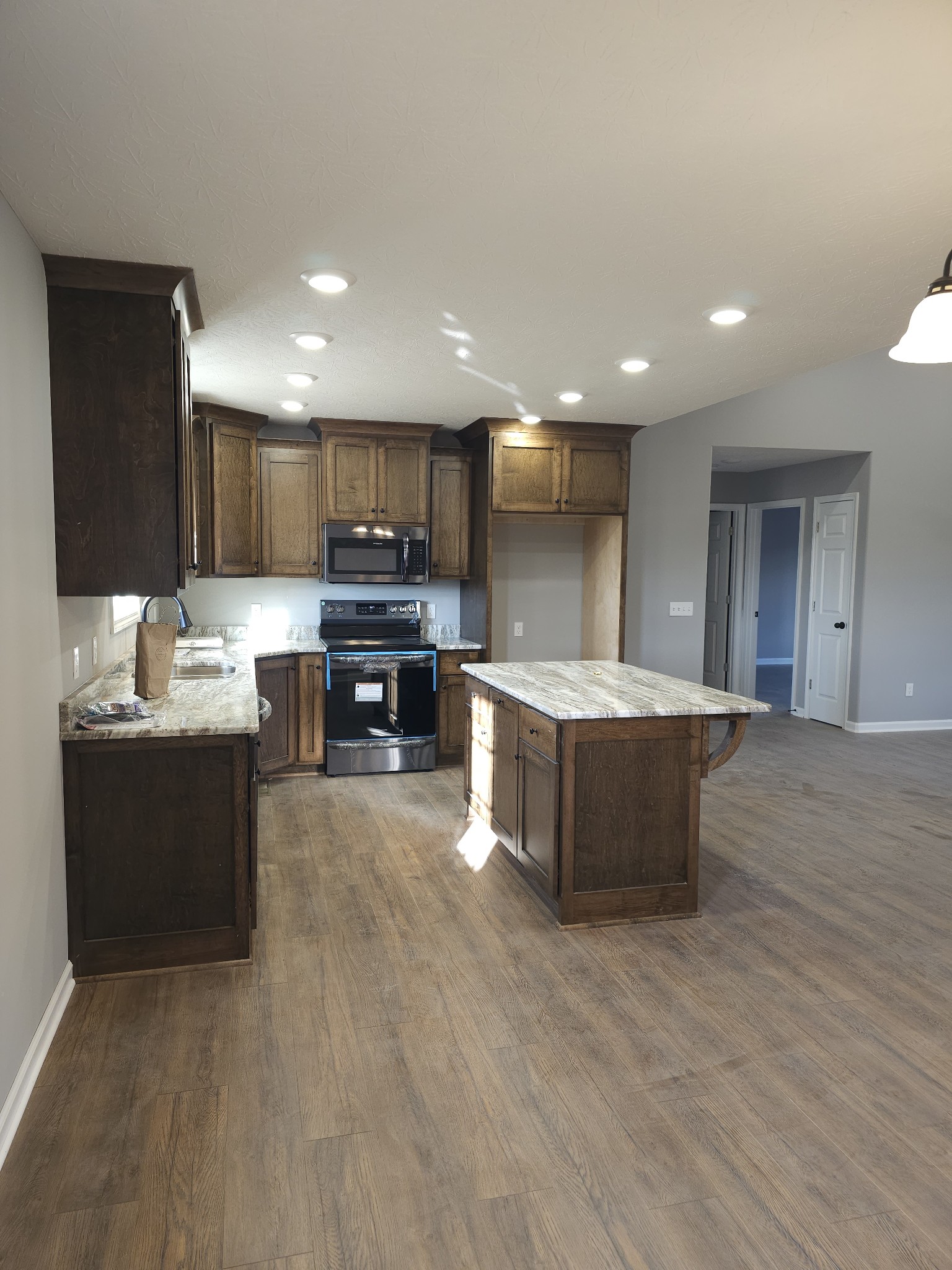5209 Galen Road Lafayette, TN 37083 - Photo 6 of 24 a large kitchen with stainless steel appliances kitchen island granite countertop a large counter top and a stove top oven