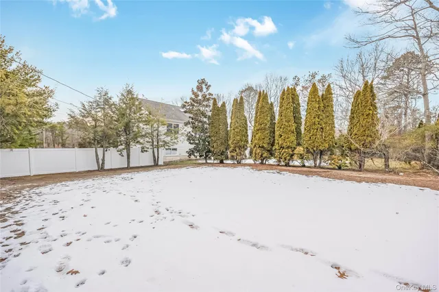a view of a deck with two chair and wooden floor