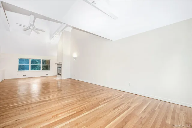 a kitchen with stainless steel appliances wooden floor a sink and a refrigerator