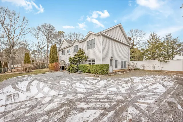a view of a house with a yard covered in snow