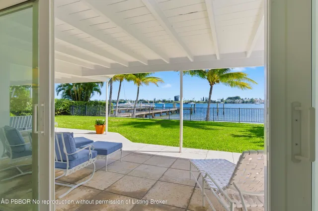 a view of a house with backyard porch and sitting area