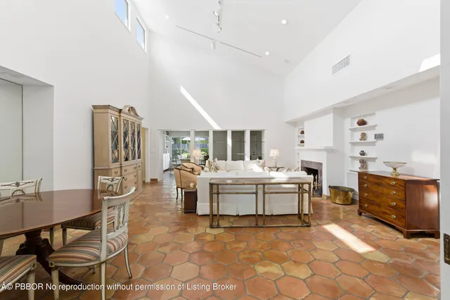 a bedroom with furniture and a large window