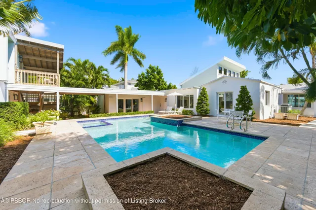 a view of a house with swimming pool and a porch