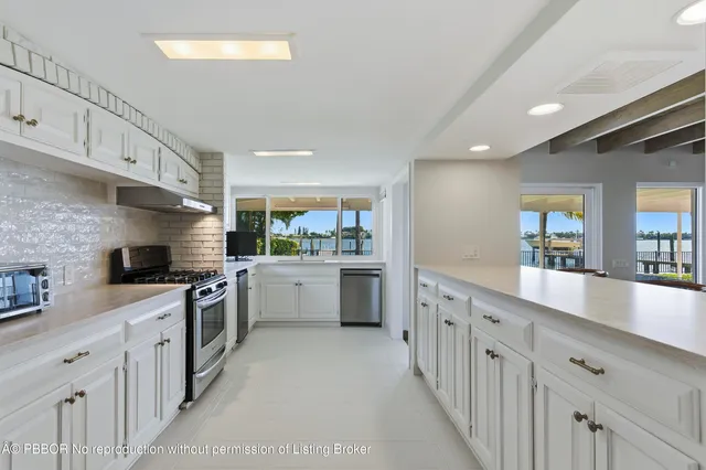 a large kitchen with stainless steel appliances lots of counter space sink and cabinets