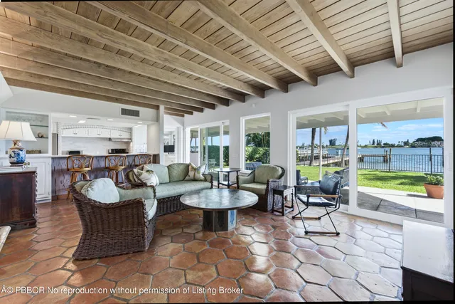 a living room with fireplace furniture and a large window