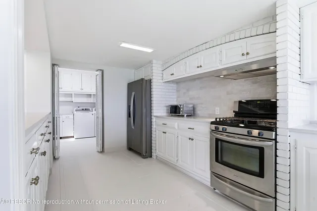 a kitchen with white cabinets and white appliances