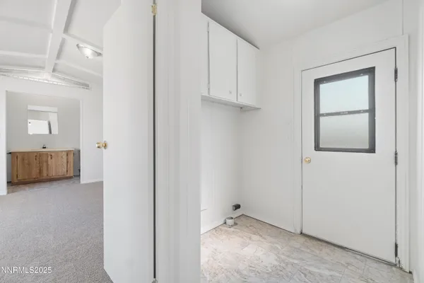 a view of an empty room and closet area