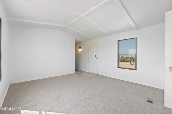 an empty room with a empty space and window