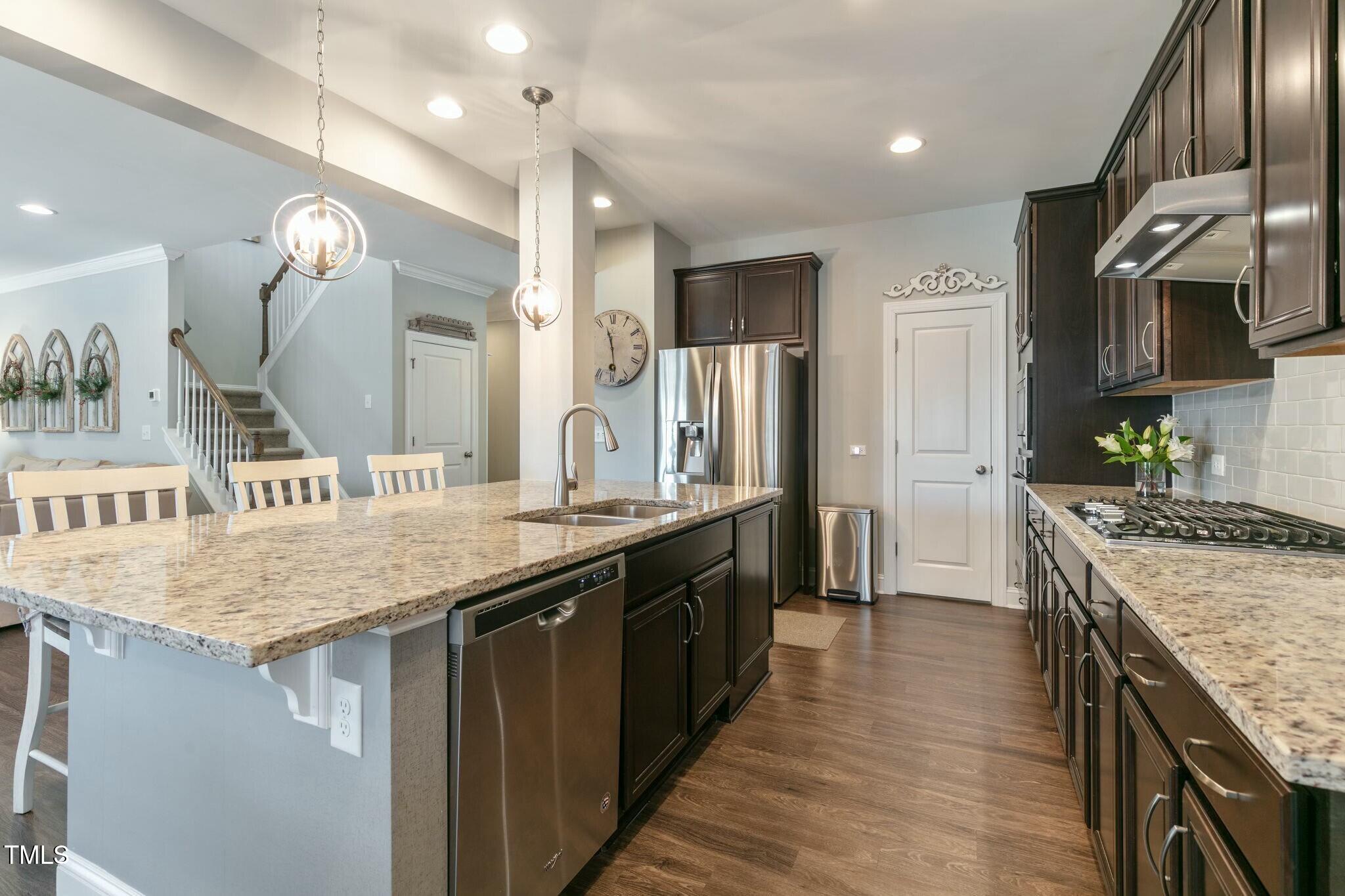 3508 Longleaf Estates Drive Raleigh, NC 27616 - Photo 10 of 45 a kitchen with stainless steel appliances granite countertop wooden cabinets a sink a stove and a refrigerator