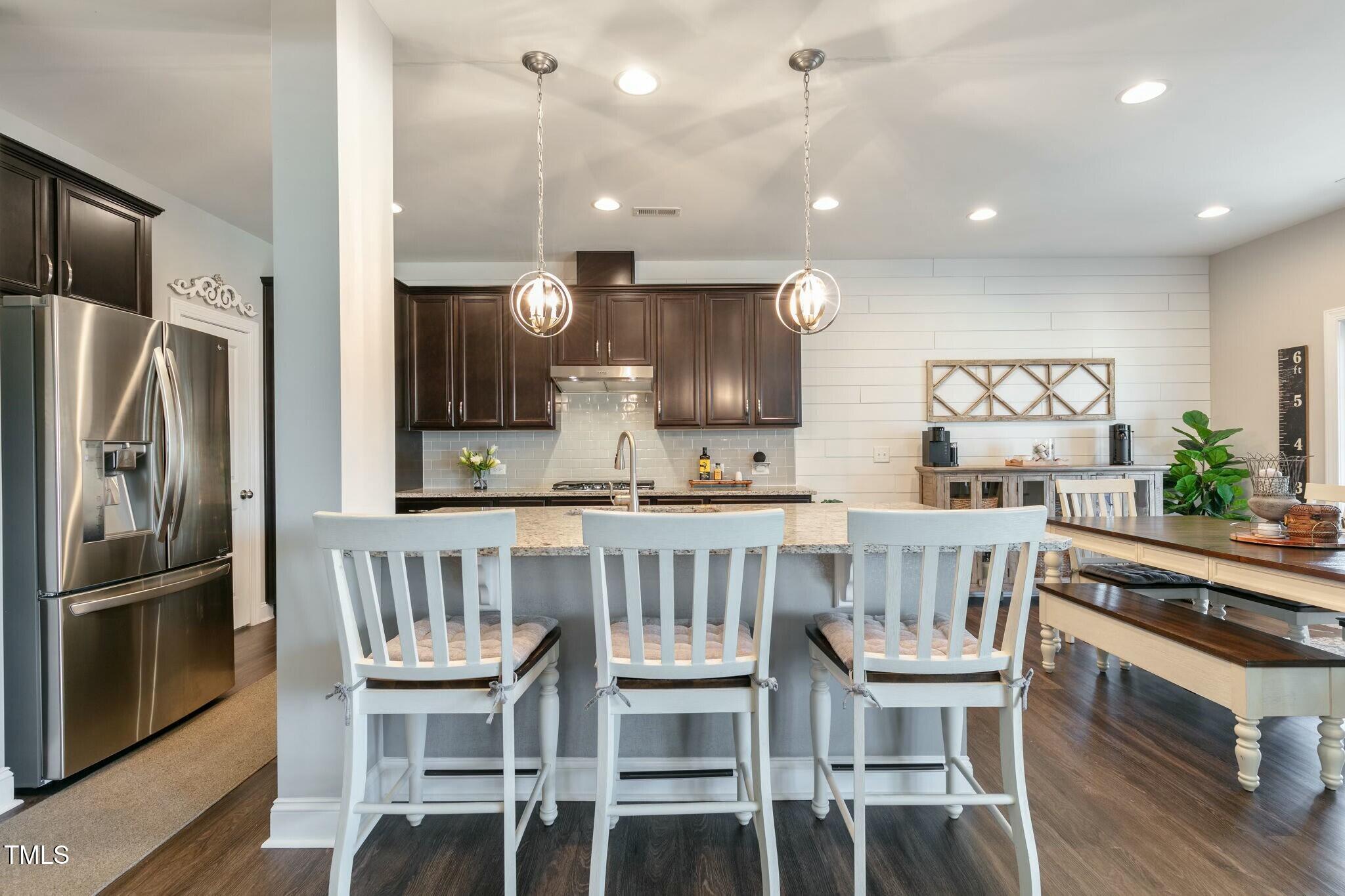 3508 Longleaf Estates Drive Raleigh, NC 27616 - Photo 11 of 45 a kitchen with a table chairs refrigerator and microwave