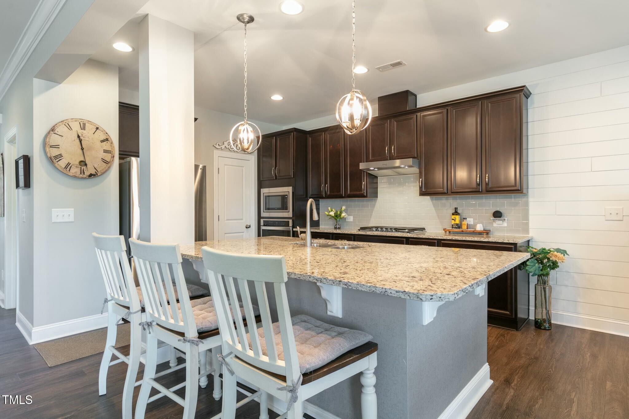 3508 Longleaf Estates Drive Raleigh, NC 27616 - Photo 12 of 45 a kitchen with a table a sink and refrigerator