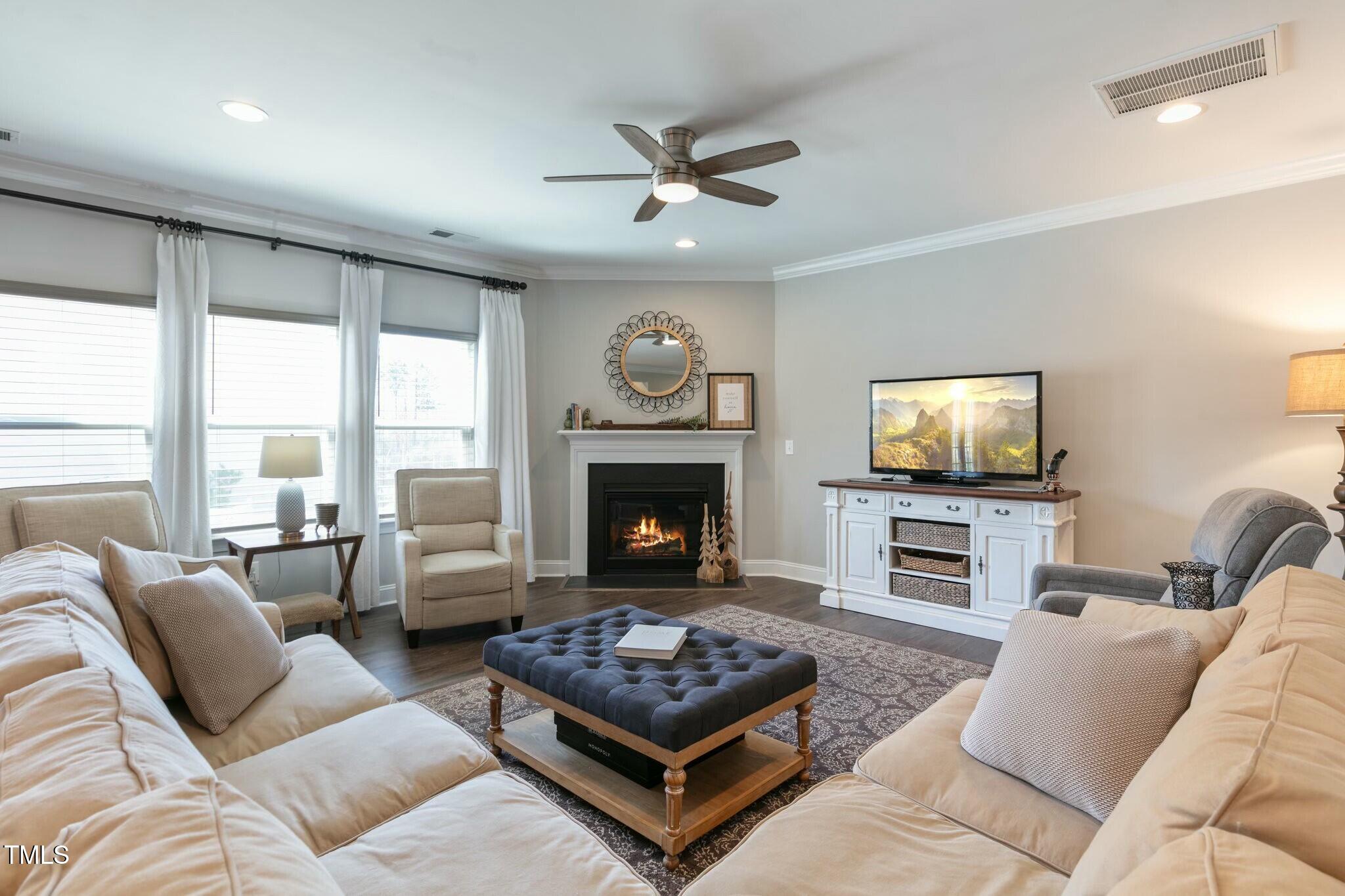 3508 Longleaf Estates Drive Raleigh, NC 27616 - Photo 16 of 45 a living room with furniture a flat screen tv and a fireplace