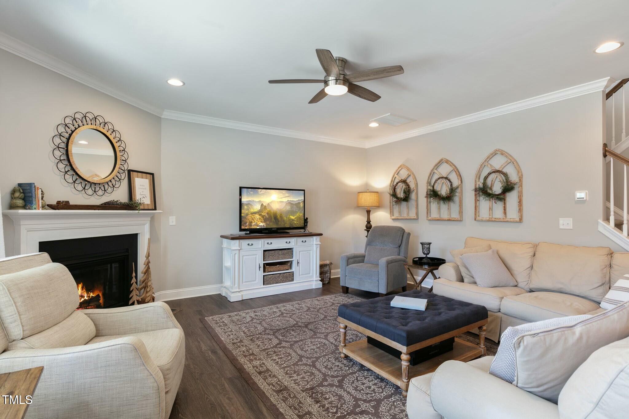 3508 Longleaf Estates Drive Raleigh, NC 27616 - Photo 17 of 45 a living room with furniture a fireplace and a flat screen tv