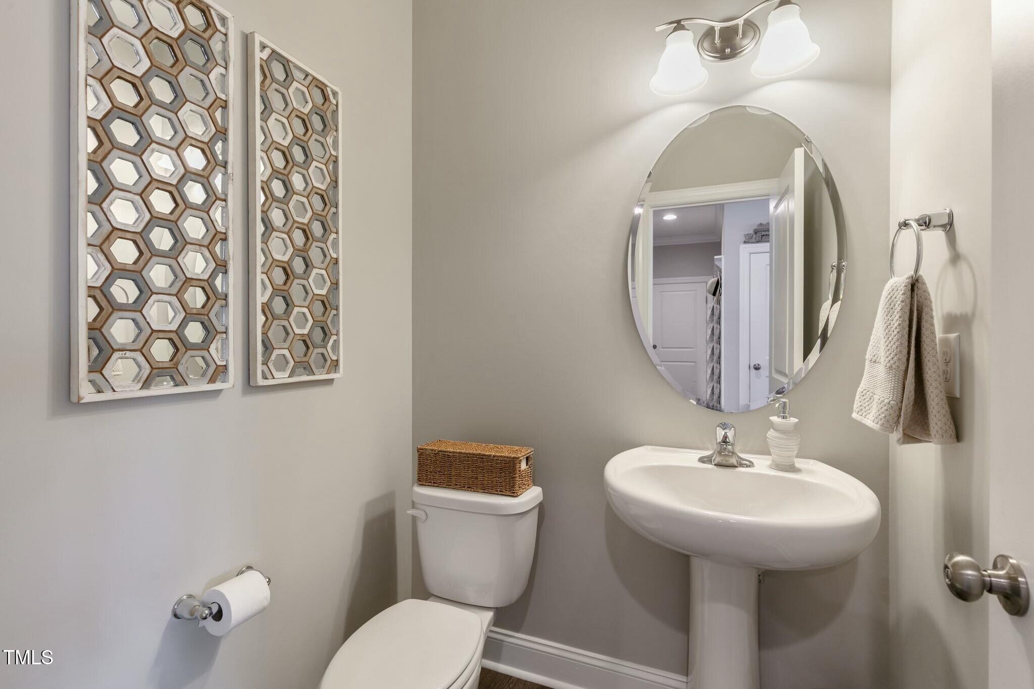 3508 Longleaf Estates Drive Raleigh, NC 27616 - Photo 19 of 45 a bathroom with a toilet sink and mirror