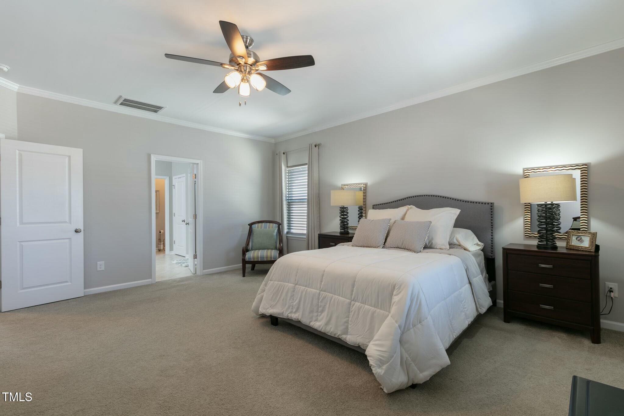 3508 Longleaf Estates Drive Raleigh, NC 27616 - Photo 23 of 45 a spacious bedroom with a bed and a ceiling fan