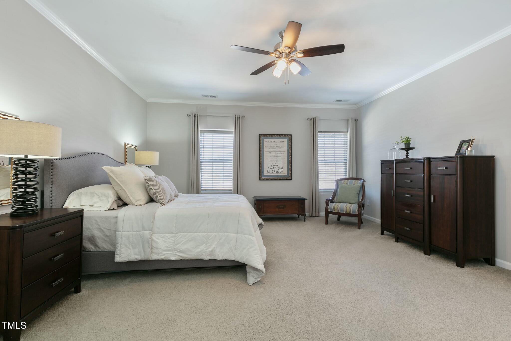 3508 Longleaf Estates Drive Raleigh, NC 27616 - Photo 24 of 45 a spacious bedroom with two beds and a chandelier