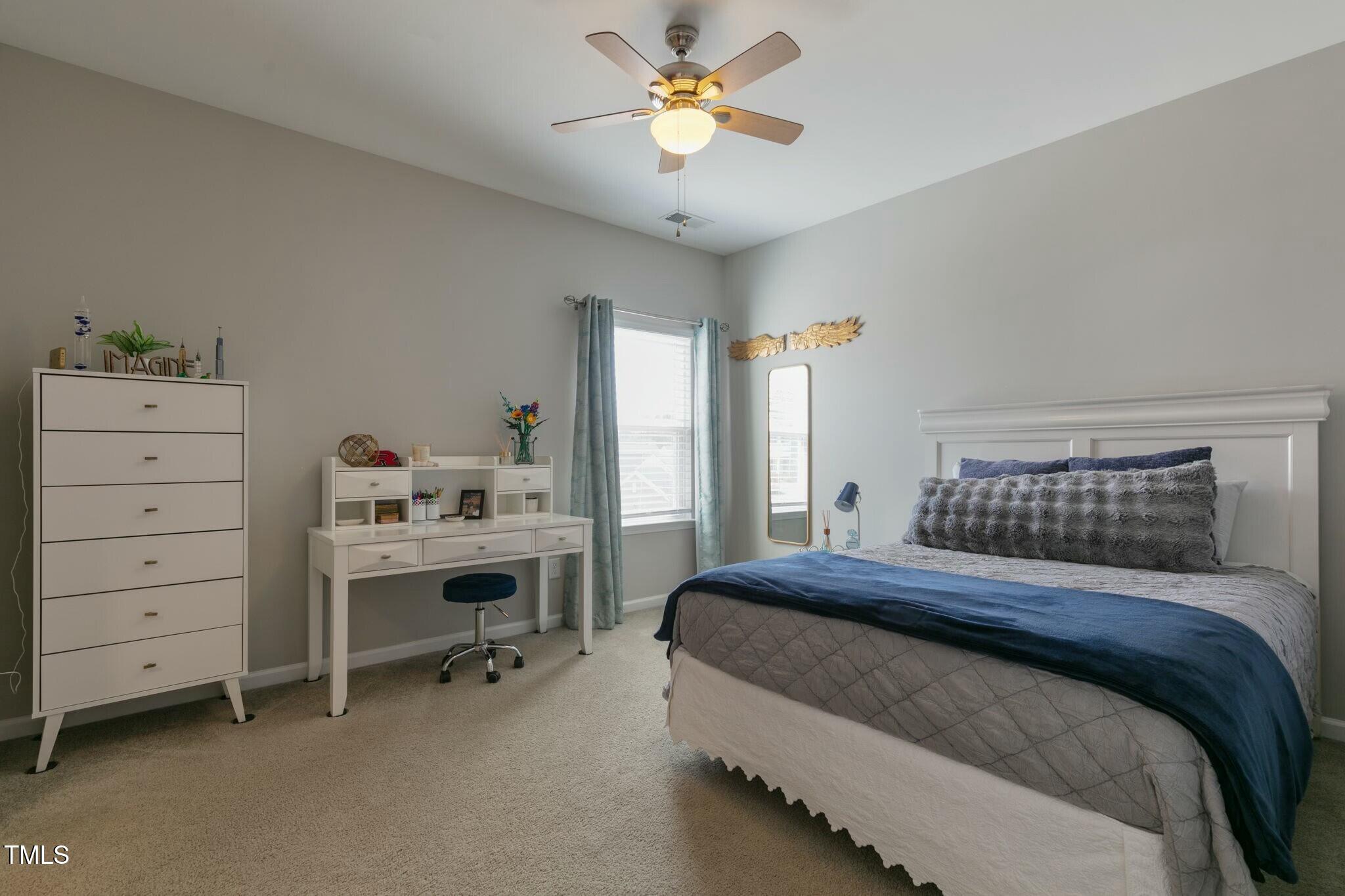 3508 Longleaf Estates Drive Raleigh, NC 27616 - Photo 28 of 45 a bedroom with a bed and a chandelier