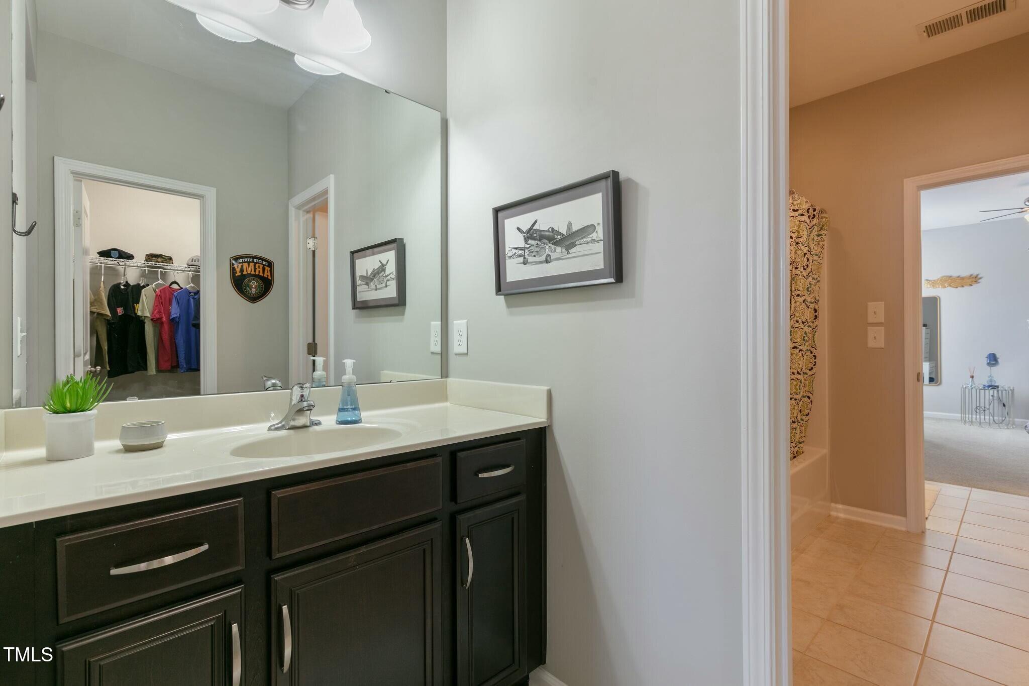 3508 Longleaf Estates Drive Raleigh, NC 27616 - Photo 29 of 45 a bathroom with a granite countertop sink and a mirror