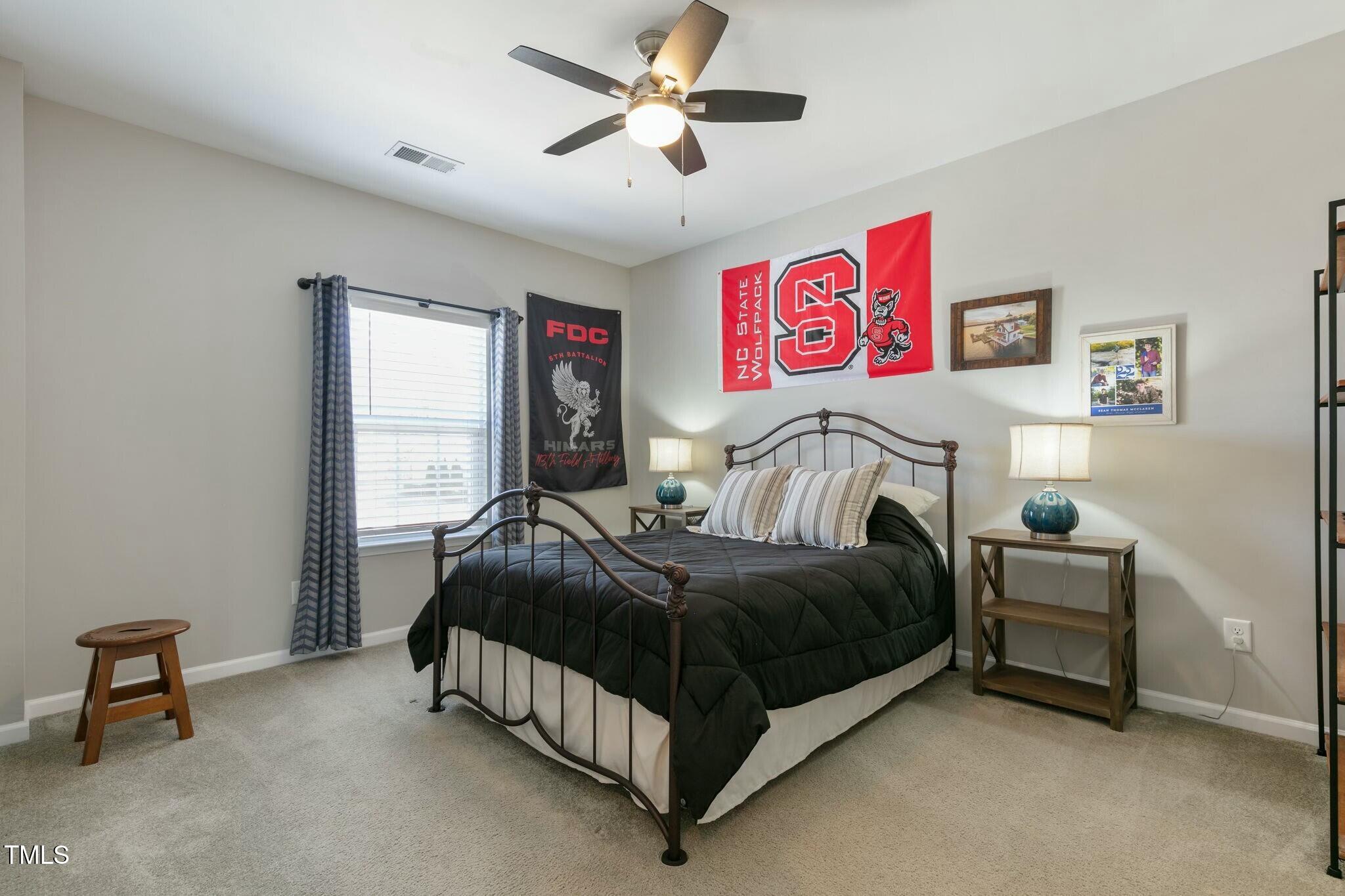 3508 Longleaf Estates Drive Raleigh, NC 27616 - Photo 30 of 45 a bedroom with a bed and a chandelier