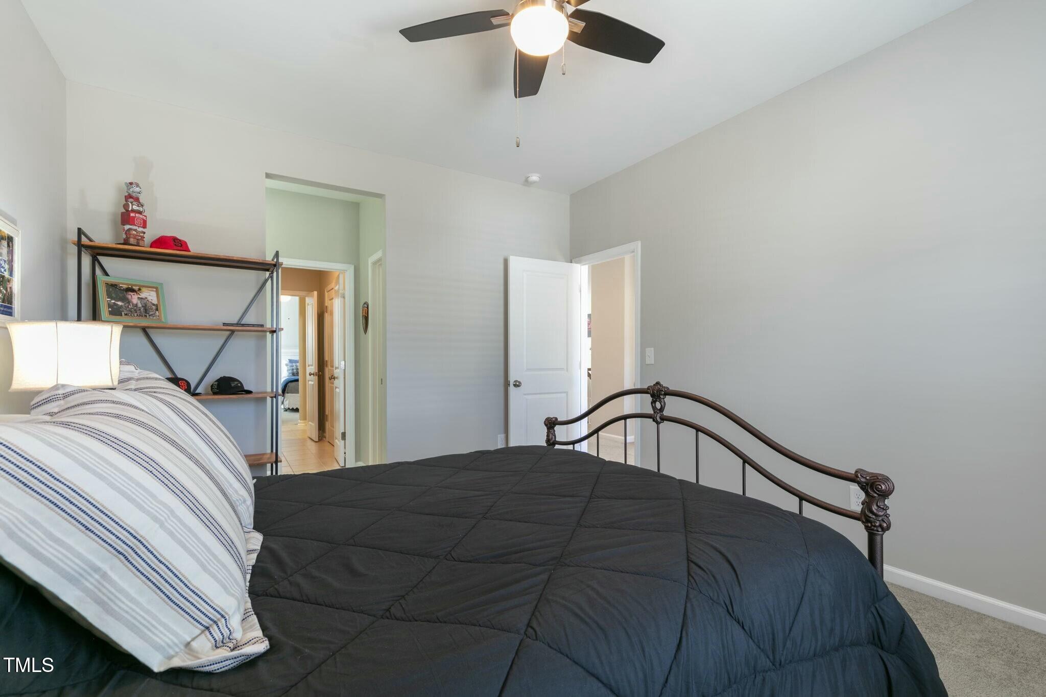 3508 Longleaf Estates Drive Raleigh, NC 27616 - Photo 31 of 45 a bedroom with a bed and a chandelier