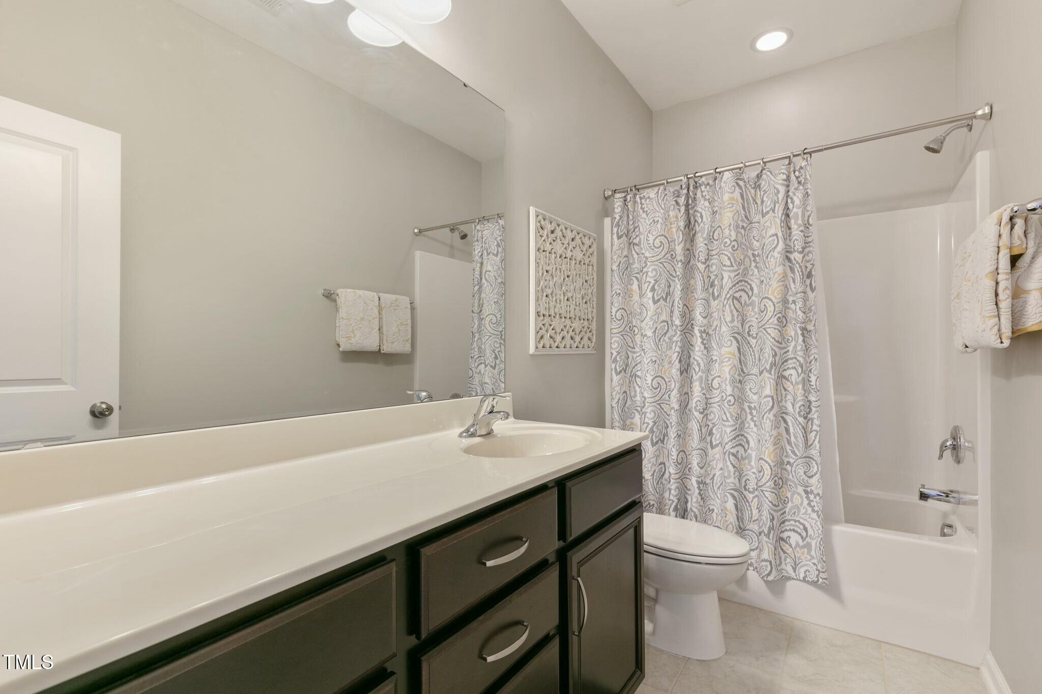 3508 Longleaf Estates Drive Raleigh, NC 27616 - Photo 34 of 45 a bathroom with a sink a toilet and shower