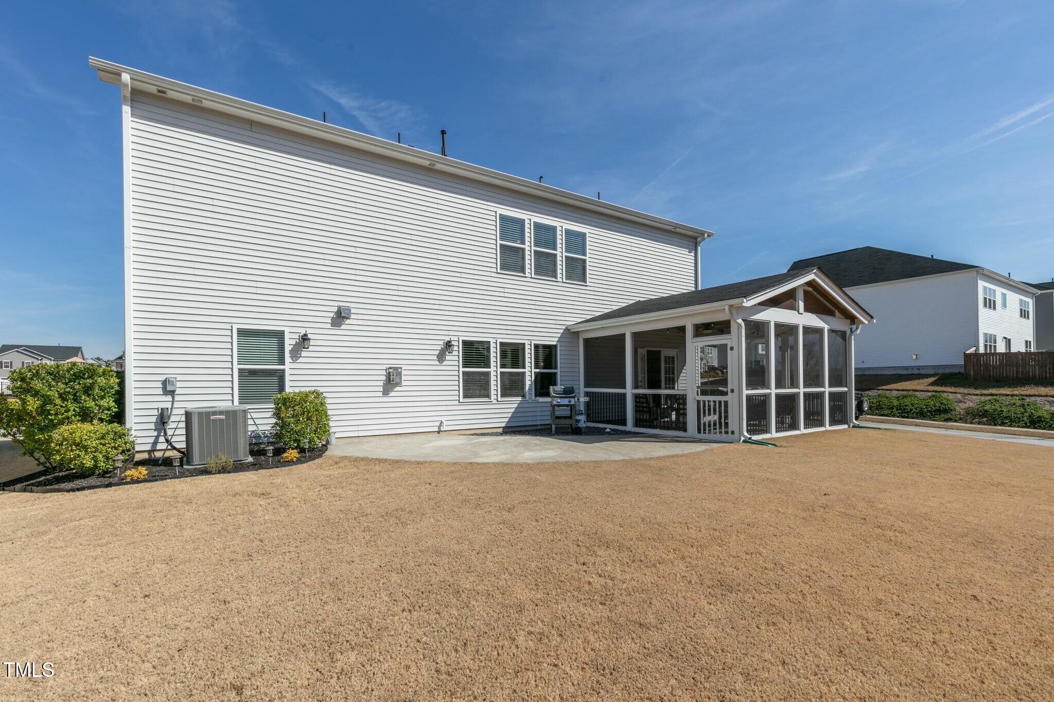 3508 Longleaf Estates Drive Raleigh, NC 27616 - Photo 40 of 45 a front view of a house with a yard and potted plants