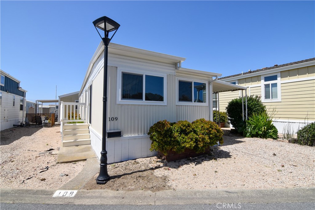 109 1st Avenue, Unit 3 Pacifica, CA 94044 - Photo 2 of 23 a front view of a house with a yard