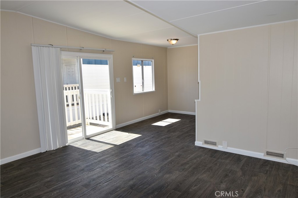109 1st Avenue, Unit 3 Pacifica, CA 94044 - Photo 5 of 23 an empty room with wooden floor and windows